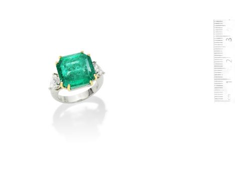 An emerald and diamond ringThe step-cut emerald, weighing 16.82 carats, between pear-shaped diamond shoulders, ring size M½Fo