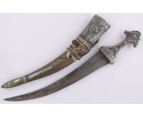 A Middle Eastern curved dagger,ornate silver filigree and brass decoration with scabbard, length overall 58cm.