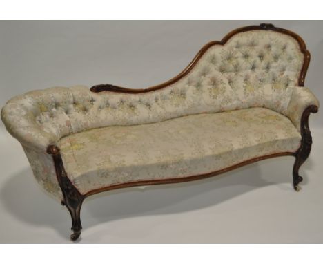 A Victorian walnut framed chair back parlour sofa,floral relief carved show wood surround with acanthus scroll arms and cabri