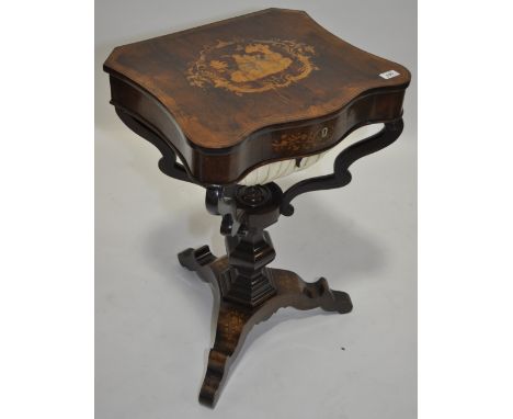 An ornate 19th century rosewood and marquetry inlaid sewing table,serpentine shaped top revealing a fitted interior, shaped s