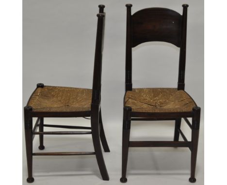 Pair of Arts & Crafts mahogany side chairs designed by William Birch,with rush seats and ring turned legs.