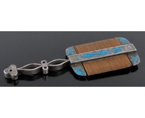 A Chinese unmarked silver and blue enamel moustache comb,circa 1900, length 9cm.