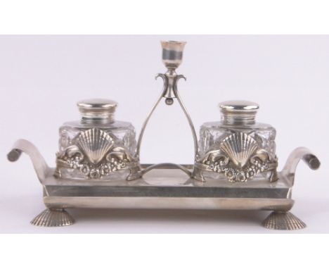 A Victorian silver desk stand,with central taper stick, cut-glass inkwells in cast shell holders on shell feet, by William Hu