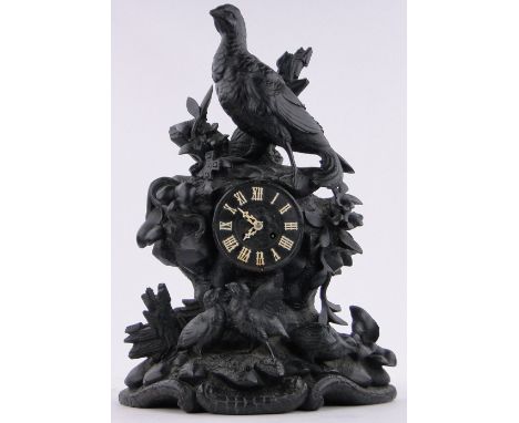 A 19th century Black Forest carved and stained wood cased mantel clock,surmounted by a pheasant and chicks, applied simulated