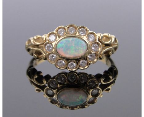 An 18ct gold opal and diamond cluster ring,setting height 10mm, size N.