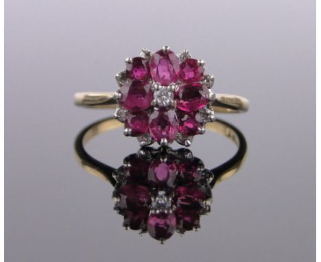 An 18ct gold ruby and diamond cluster ring,circa 1970, setting height 12mm, size R.