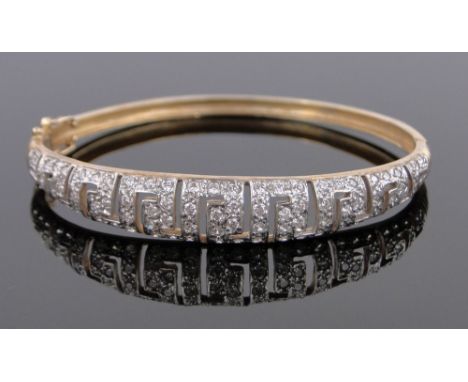 A 9ct gold stone set hinged bangle 11.7g.