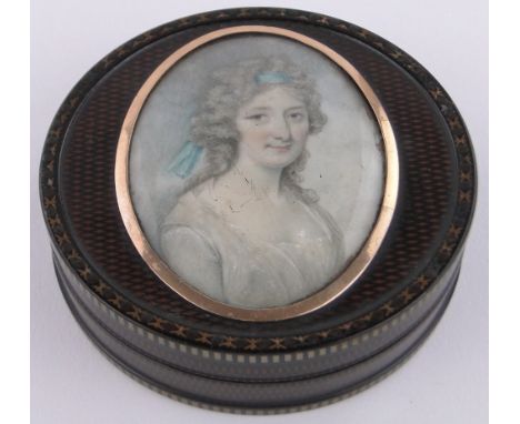 An 18th century circular tortoiseshell box,with inset miniature watercolour portrait of a woman on ivory, unmarked gold surro