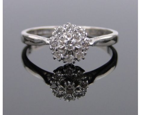 An 18ct white gold diamond cluster ring,setting 8mm across, size Q.