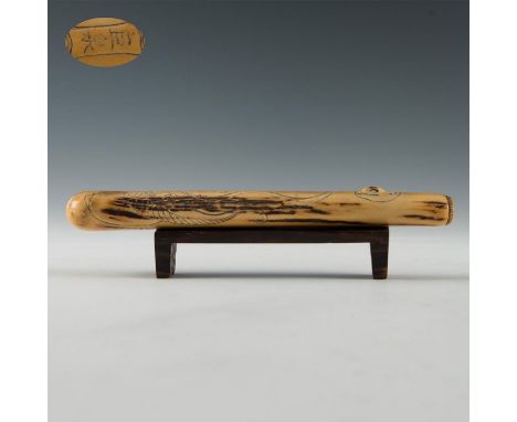 Carved bone pipe case depicting dragon.Comes with a wooden stand. Signed. Dimensions: 8"LCountry of Origin: Japan Condition: 