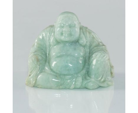 Carved from a single piece of jade.Modeled in the form of a seated Buddha, his amusement spreading across his wide and smilin