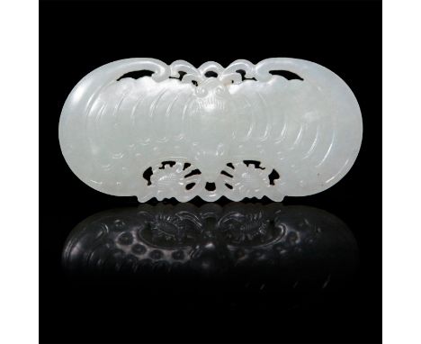Carved from a single piece of white jade, modeled with a stylized bat on each side, and floral decorations in open work. Issu
