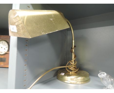 A brass desk top light with goose neck