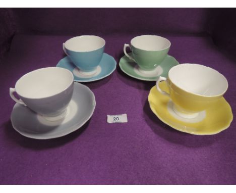 A selection of harlequin tea cups and saucers