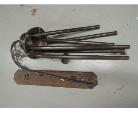 A large brass wind chime with wall bracket