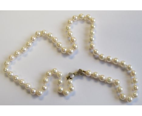 A single row of Cultured Pearls on bow shaped clasp set two eight-cut diamonds