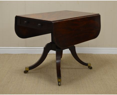 A Regency mahogany dropleaf Table fitted two drawers on turned central column, quadruple splay base with brass toe caps and c