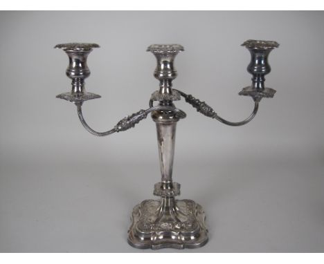 An Elizabeth II silver two branch three light Candle Holder with tapering column on shaped square base having foliate bands, 