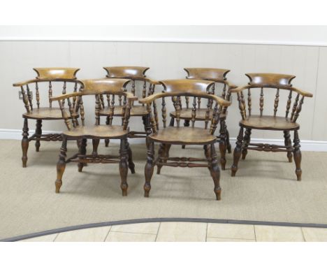 A Set of six 19th Century bow back Chairs, the shaped crests and swept arms raised on splindle turnings above elm seats, on t