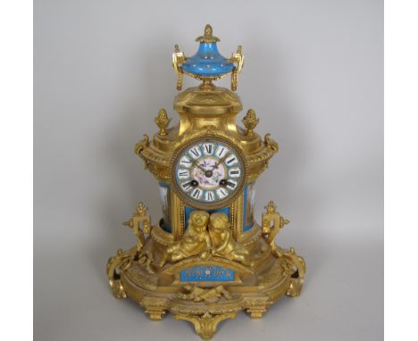A 19th Century French Mantel Clock with inset Sevres style panels painted landscapes, etc, circular dial, 8-day movement in o