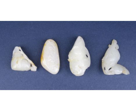 Four Chinese pale celadon Jade Pendants, Late Qing Dynasty or later, comprising a double lotus pod, a peach, a pair of carp, 