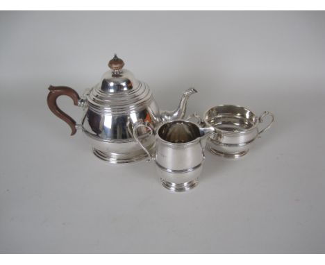 A George V silver three piece Tea Service of circular form, Birmingham 1925