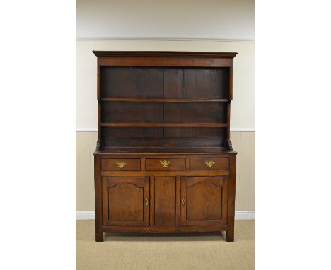A Georgian oak Dresser with boarded canopy Rack, the enclosed base fitted three drawers above pair of arch panelled doors, 4f
