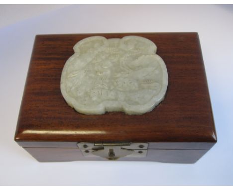 A Chinese hardwood Box, late Qing Dynsty or later, the hinged lid fitted with a ruyi head-shaped pale celadon Jade plaque, ca