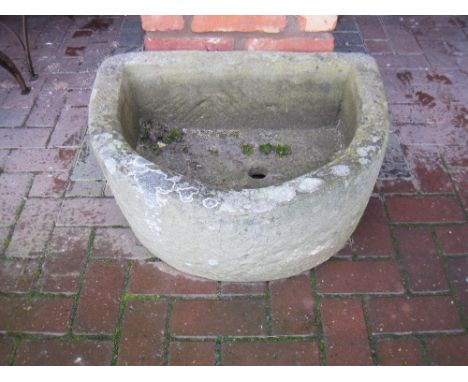 A stone D-shape Pump Trough, 27 x 21in