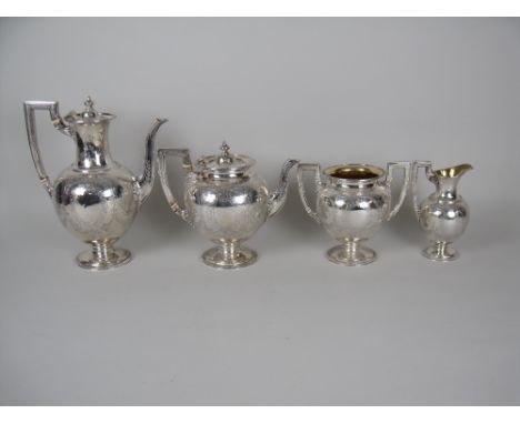 A Victorian silver four piece Tea and Coffee Service with floral and leafage engraving, vacant oval cartouches, beaded rims, 