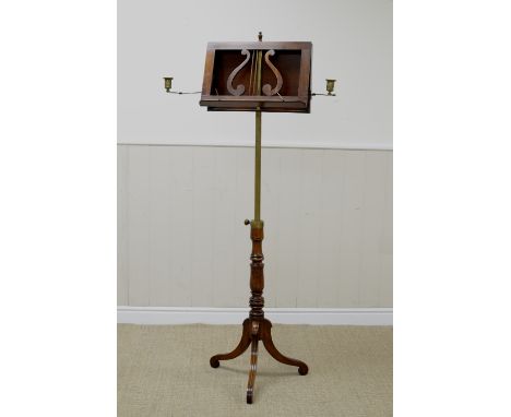 A Regency mahogany Music Stand with lyre rest and hinged candle branches on adjustable brass and turned column with tripod ba