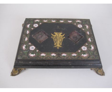 A 19th Century ebonised Inkstand Base with gilt monogram (lacks coronet), pink and green enamel floral frieze on four jewelle