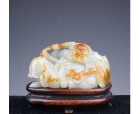 A fine Chinese carved Jade figure of Li Tieguai, 18th/19th Century, of pale celadon colour with russet details, the immortal 