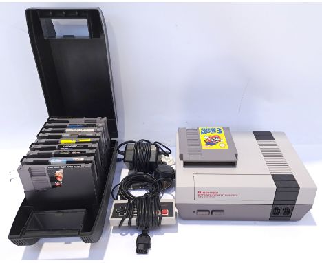 Nintendo Entertainment System (NES) Games Console and a Collection of Video Games. Includes "Super Mario Bros. 3" with others