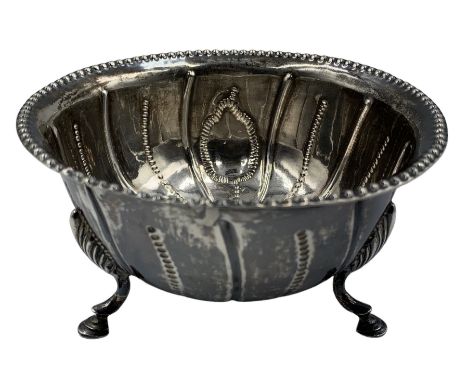 Early 19th century Irish silver circular bowl of fluted and beaded design on triple shaped supports, engraved to the base wit