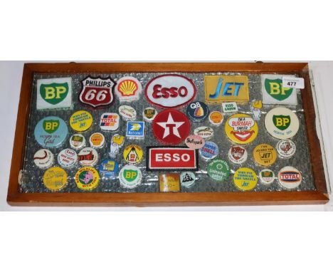 Framed collection of oil and petrol company pin badges and patches, Phillips, BP, Jet, Shell etc, approx 45, 25cm X 50cm
