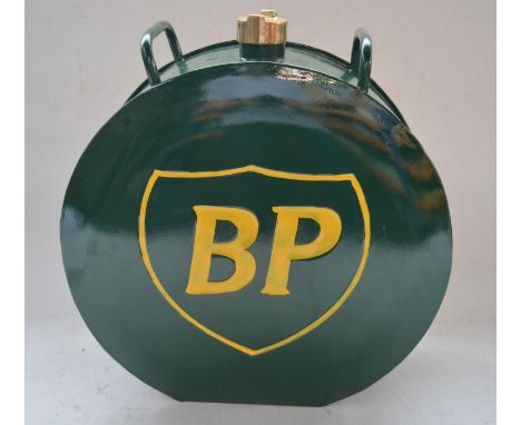 Two steel fuel/oil cans, BP (restored and repainted, possible reproduction), H39cm and a vintage Valor can, H34.5cm. 