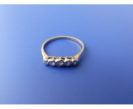 A five stone graduated collet set diamond ring in yellow metal.  Finger size P/Q.