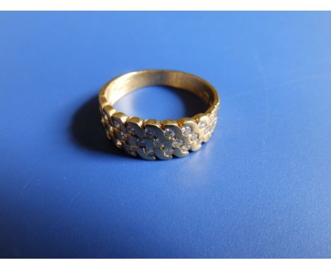 A modern diamond set 18ct gold band ring having three rows of small stones, total diamond weight approximately 0.70 carat.