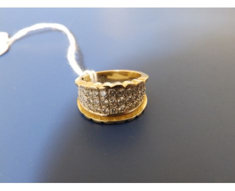 An 18K graduated diamond band ring set with three half rows of diamonds.  Finger size L.