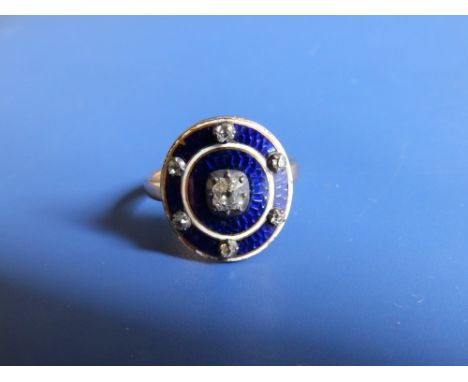 A 19thC diamond set &amp; guilloche enamelled target ring in '15ct' yellow metal, decorated in royal blue &amp; white and wit
