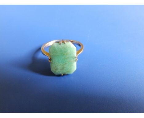 A '9c' ring set with a rectangular jade coloured stone.  Finger size  F.