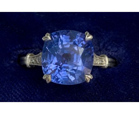 An early 20thC certified natural Sri-Lankan colour-change sapphire ring, the shoulders millegrain set with six small diamonds