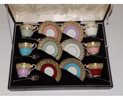 A cased Aynsley coffee set with silver spoons.