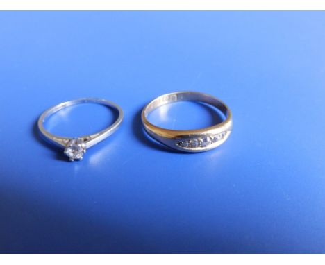 A small diamond solitaire and a five stone band ring. (2)