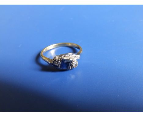 A sapphire &amp; diamond three stone crossover set yellow metal ring.  Finger size L/M.