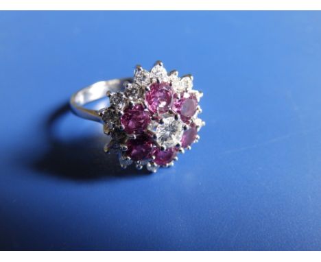 A modern ruby &amp; diamond cluster ring, total diamond weight approximately 1.25 carats, in 18ct white gold.  Finger size N.