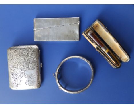 A Birmingham silver cigarette case with scroll engraved ecoration, a card case, bangle and a cheroot holder. (4)
