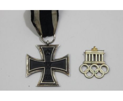 A German WWI Iron Cross second class and a 1936 XI Olympiade Berlin white enamel badge (2) 