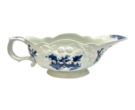 Large 18th century Lowestoft sauce boat, circa 1770, the body decorated with Hughes type floral moulding, and painted in unde